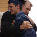 man hugging high school graduate